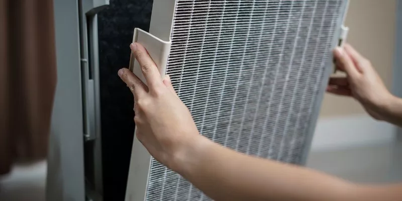 Someone changing a FIlter in a air purifier