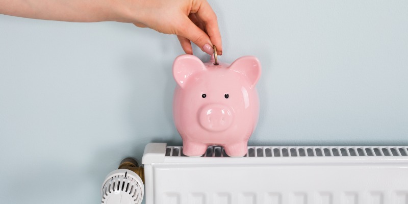Woman putting money in piggy bank on Boiler