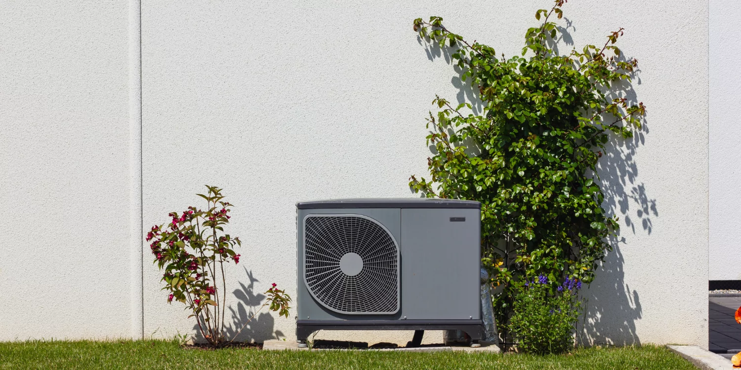 Heat Pump against a wall - Understanding HVAC Refrigerant Recharges: Frequently Asked Questions