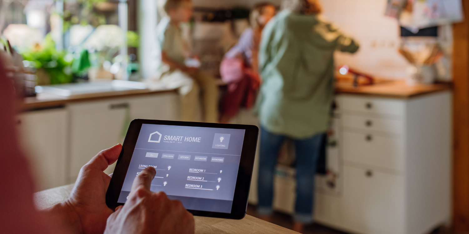 man using a smart home monitor to review home controls - 3 Major Long-Term Benefits of Installing an Air Source Heat Pump